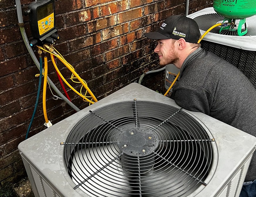 Man checking the pressure of Air Conditioner